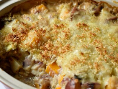 A casserole of vegetables topped with crispy cheese and panko