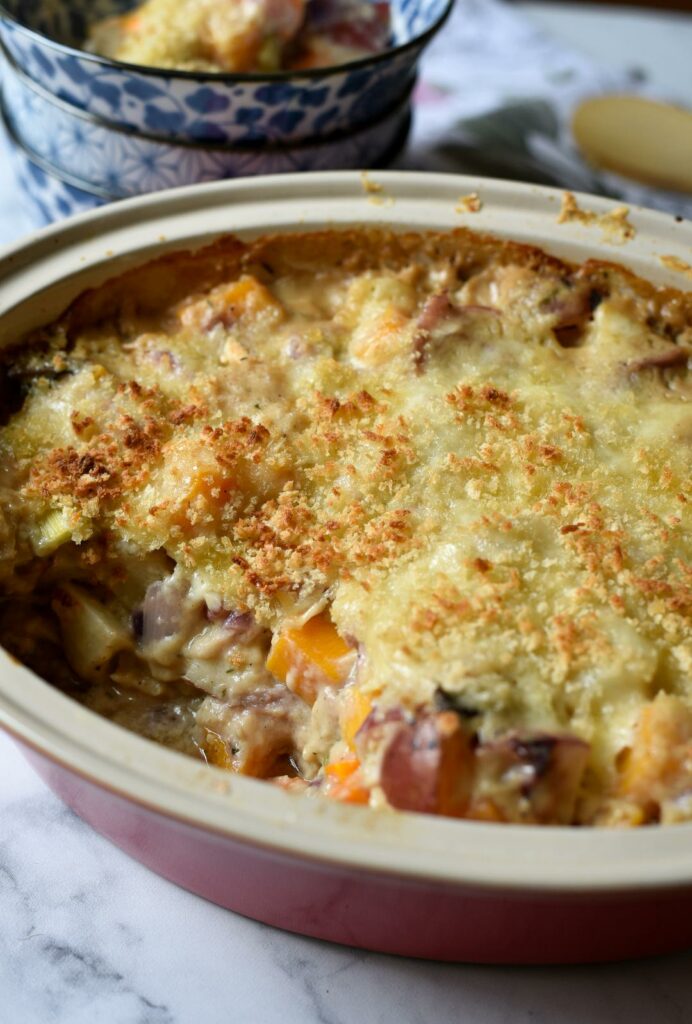 A casserole of vegetables topped with crispy cheese and panko