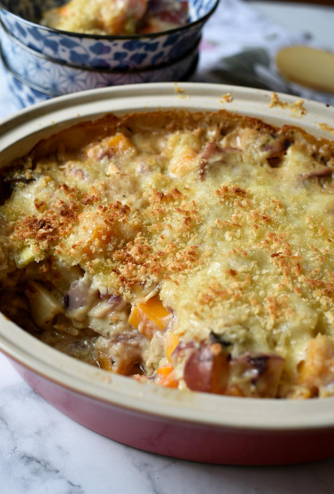 A casserole of vegetables topped with crispy cheese and panko