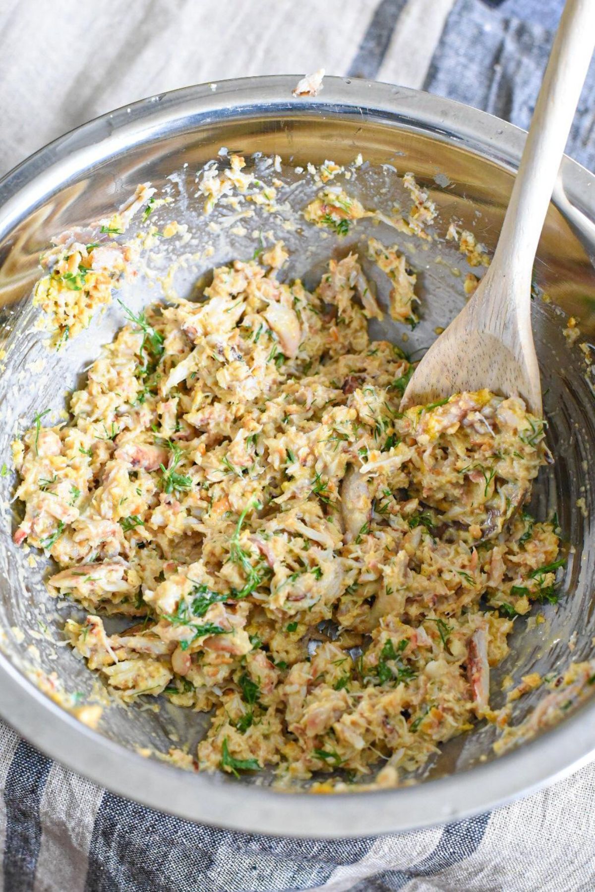 A metal bowl filled with crab cake stuffing