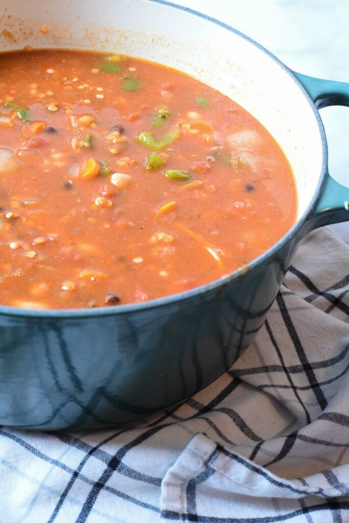 A large dutch oven filled with stovetop vegan chili.