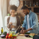 A couple in the kitchen laughing and learning tips to make home cooking easier and better