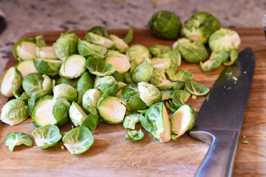 chopped brussels sprouts on a wooden cutting board
