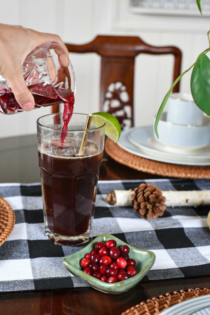 pouring cranberry juice into a coffee spritzer