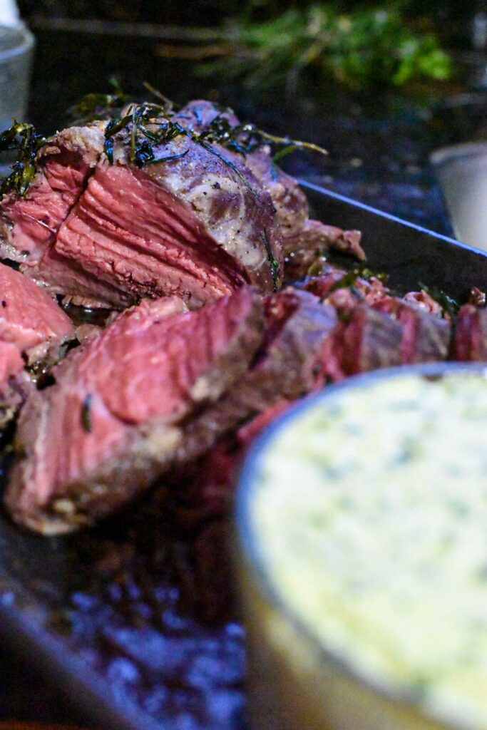 pink beef tenderloin on a baking sheet