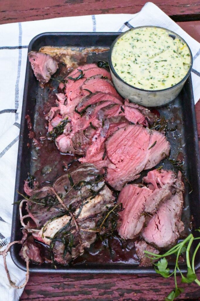 easy beef tenderloin recipe on a baking sheet with a horseradish sauce on the side