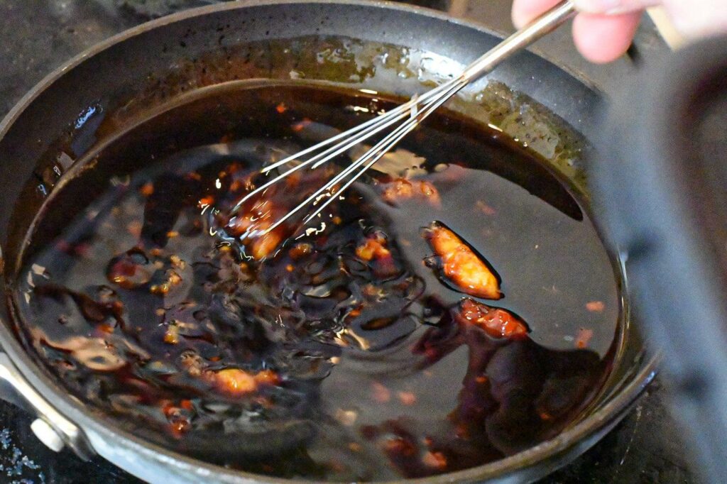 making korean sauce for chicken with a whisk