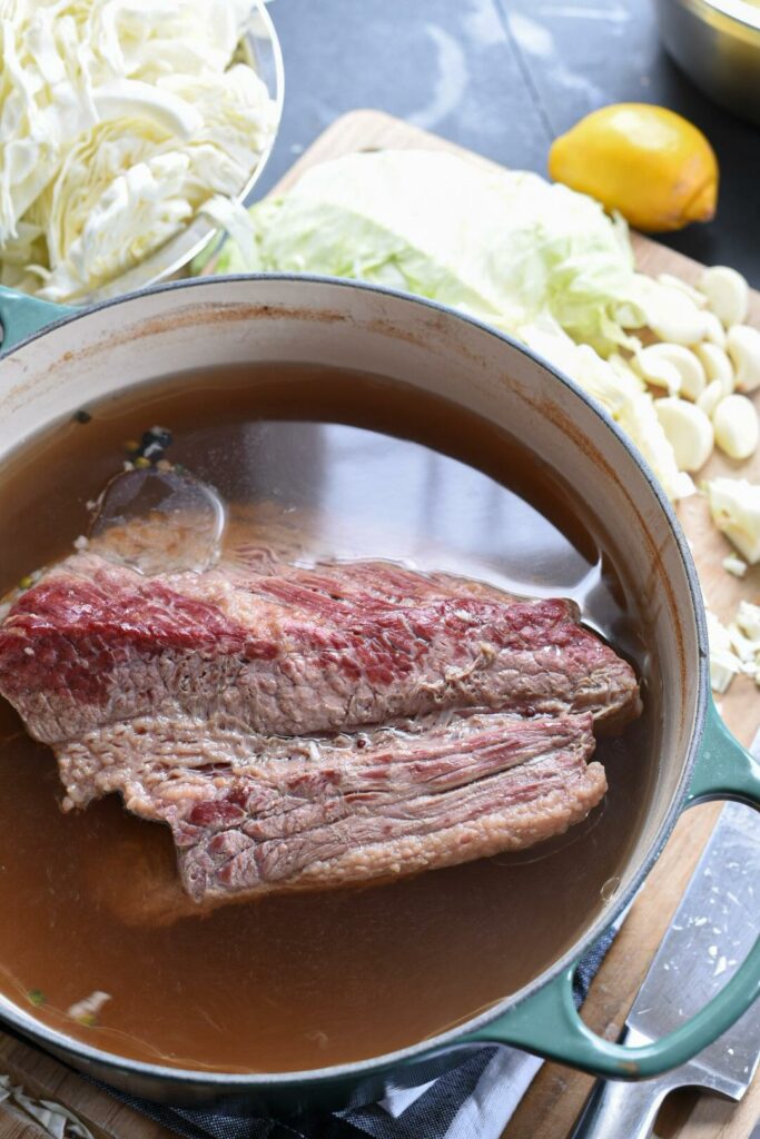 a dutch oven filled with corned beef