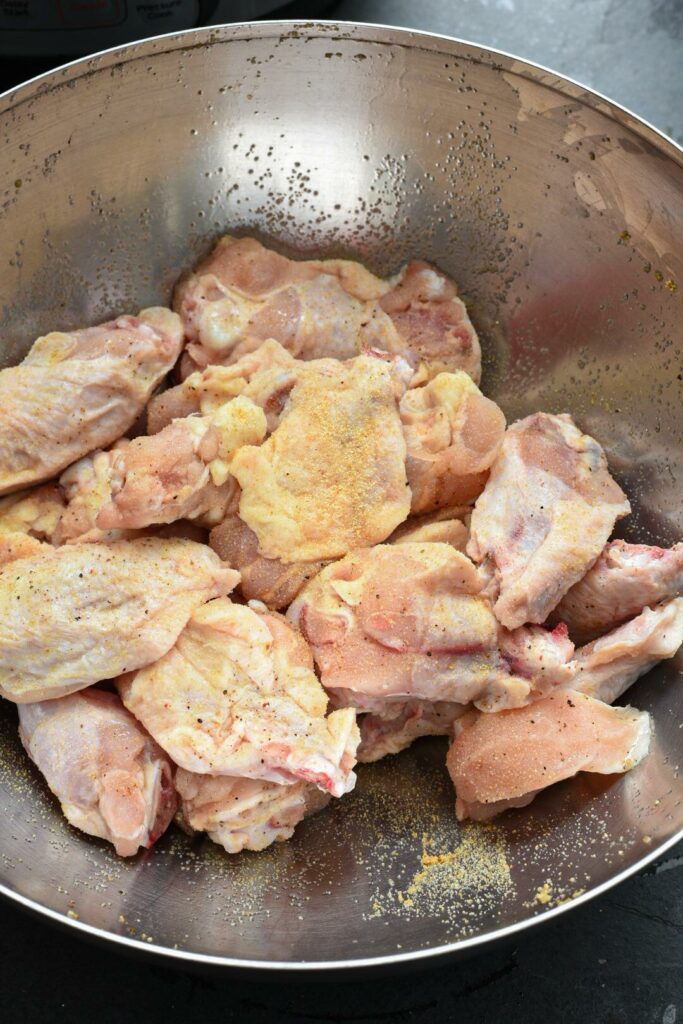 A bowl filled with raw chicken wings