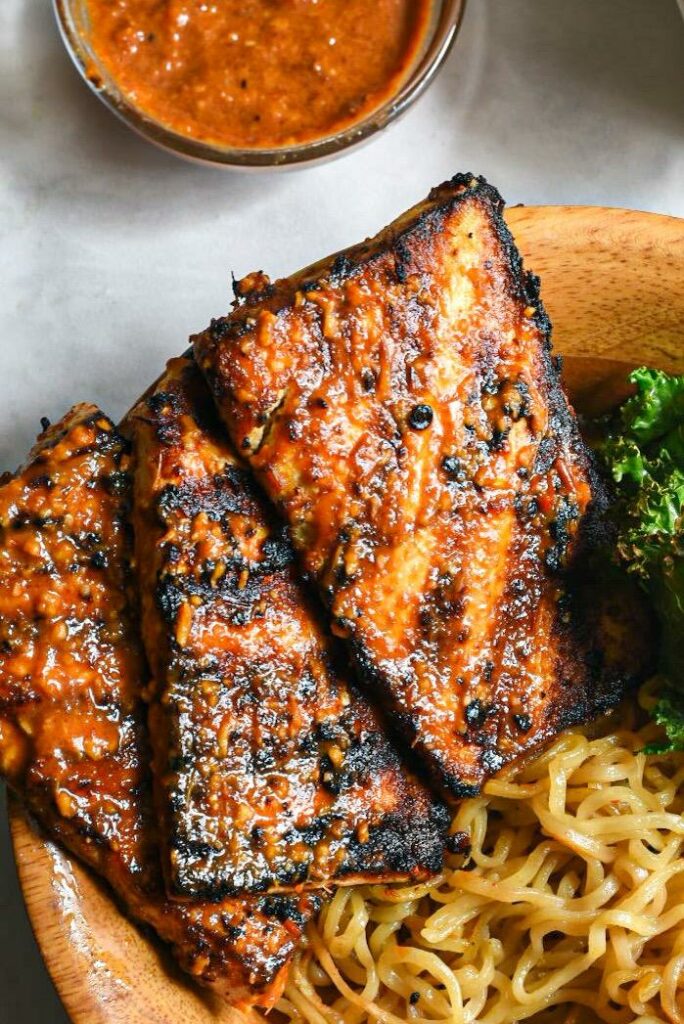 grilled tofu slices up close with black grill marks