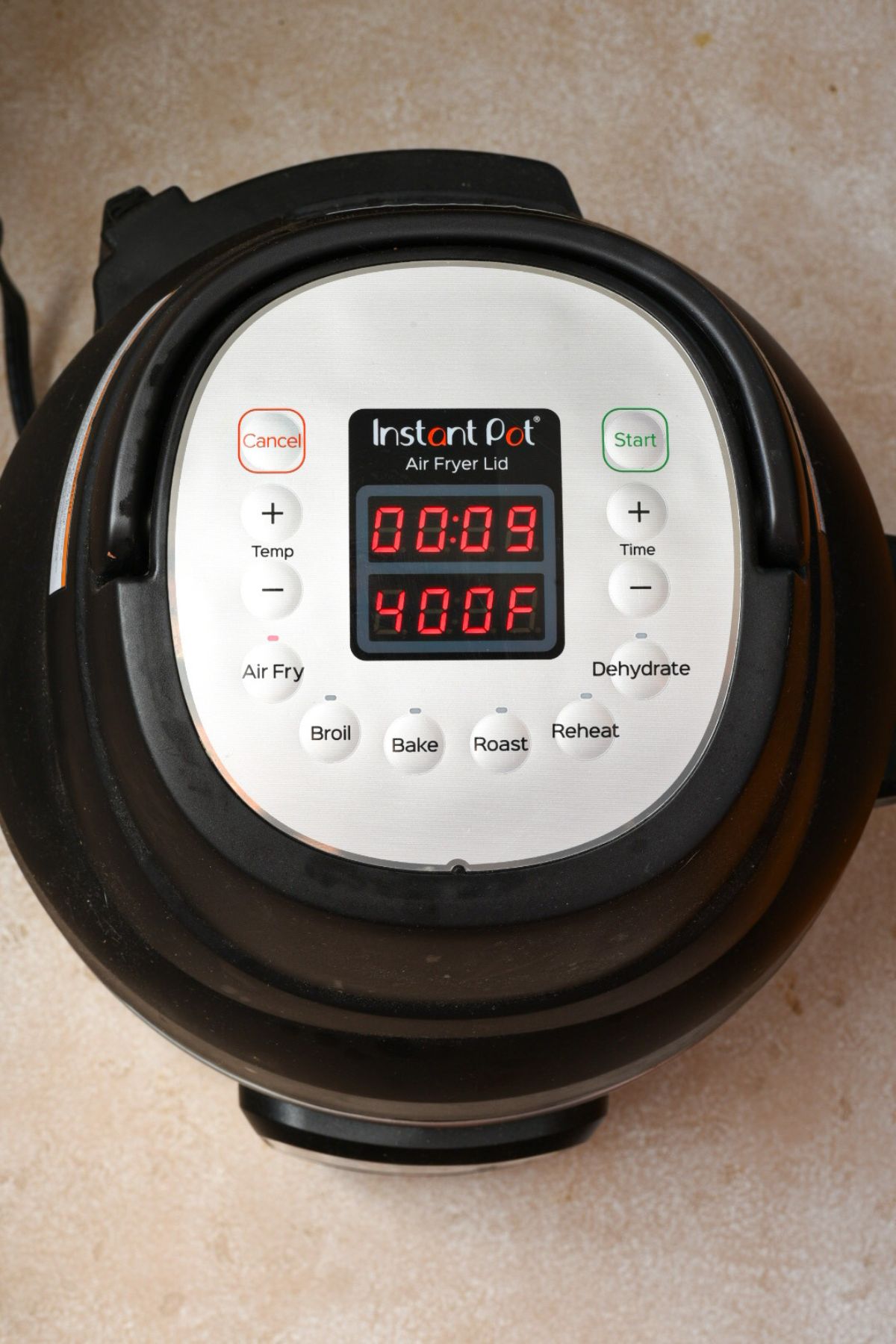 An overhead shot of an instant pot air fryer set to 9 minutes on 400 degrees