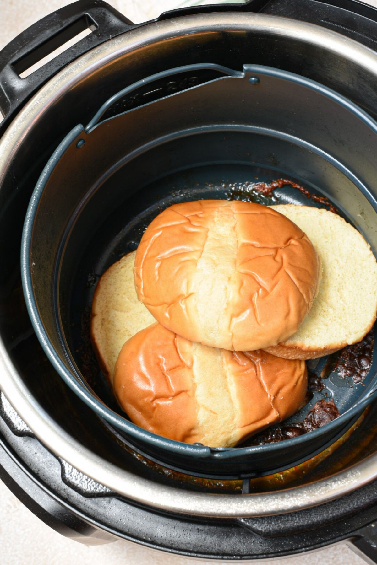 a couple of burger buns inside of an air fryer basket