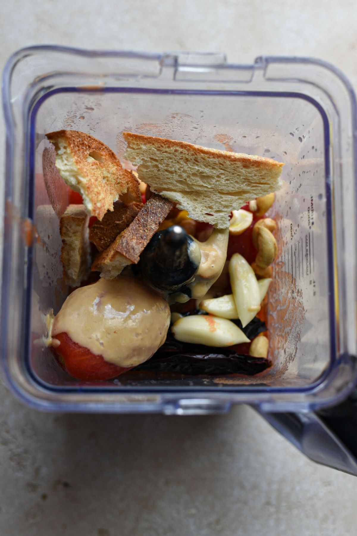An image of the top of a blender filled with the ingredients to make arrabiata sauce