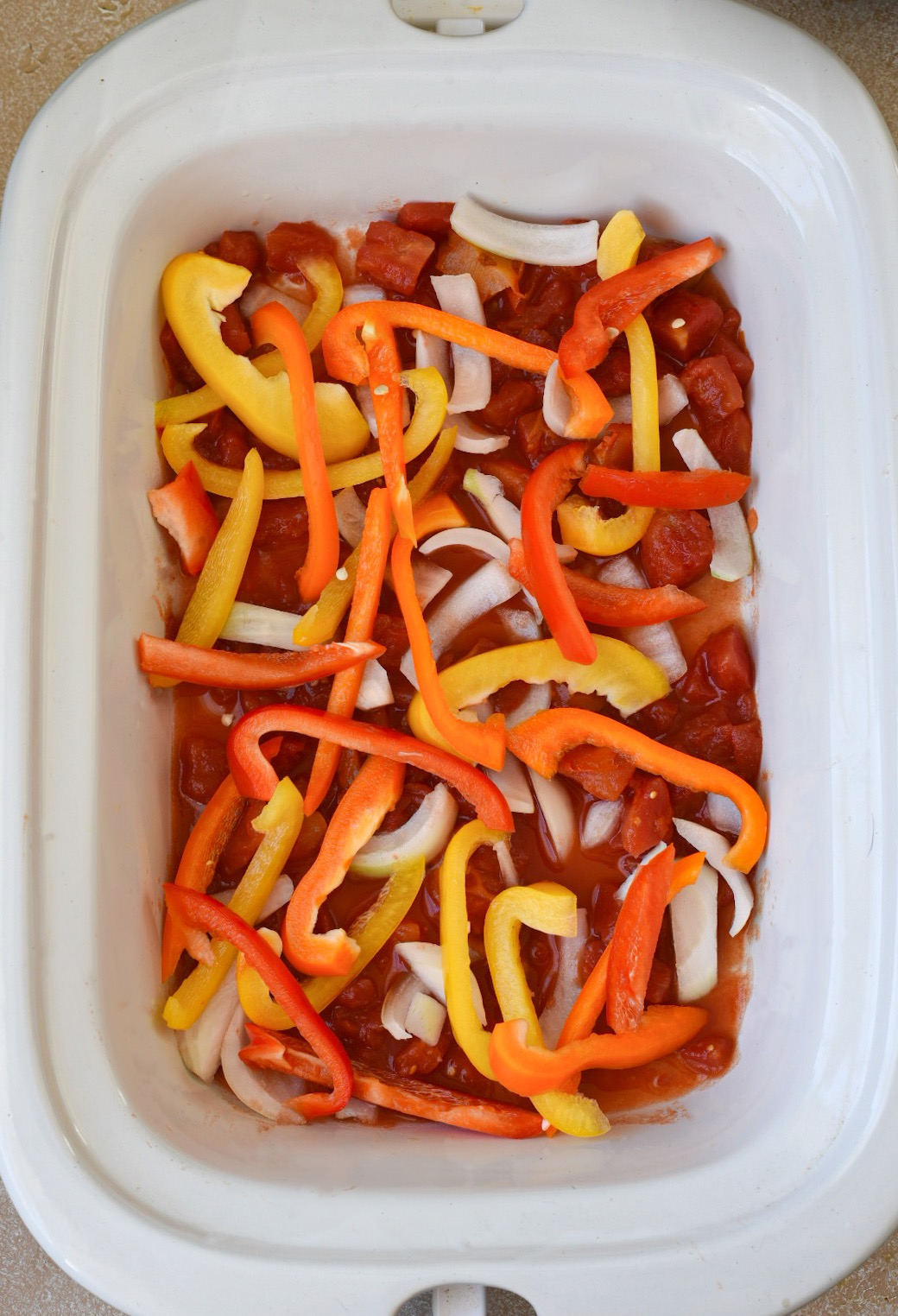 A crockpot filled with chicken fajita ingredients