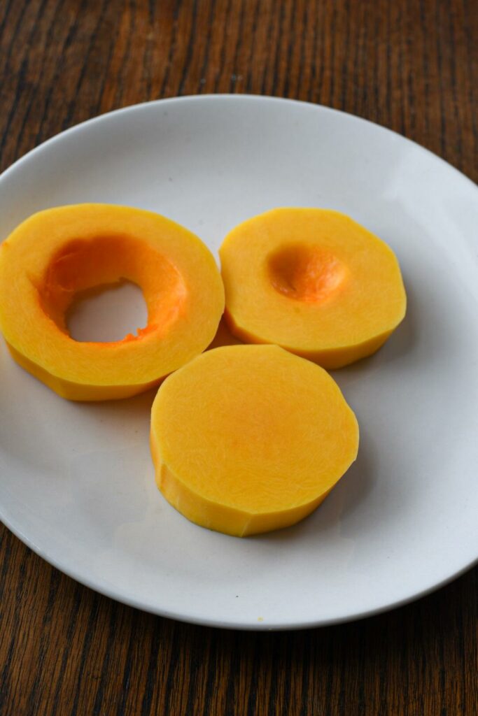 Butternut squash medallions peeled on a white plate