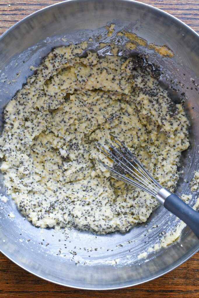 A stainless steel bowl filled with almond flour pancake batter and chia seeds