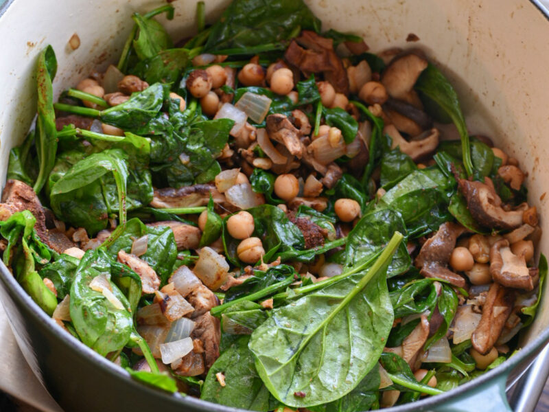 Barley salad recipe with spinach A dutch oven filled with vegetables for barley salad and bright green spinach