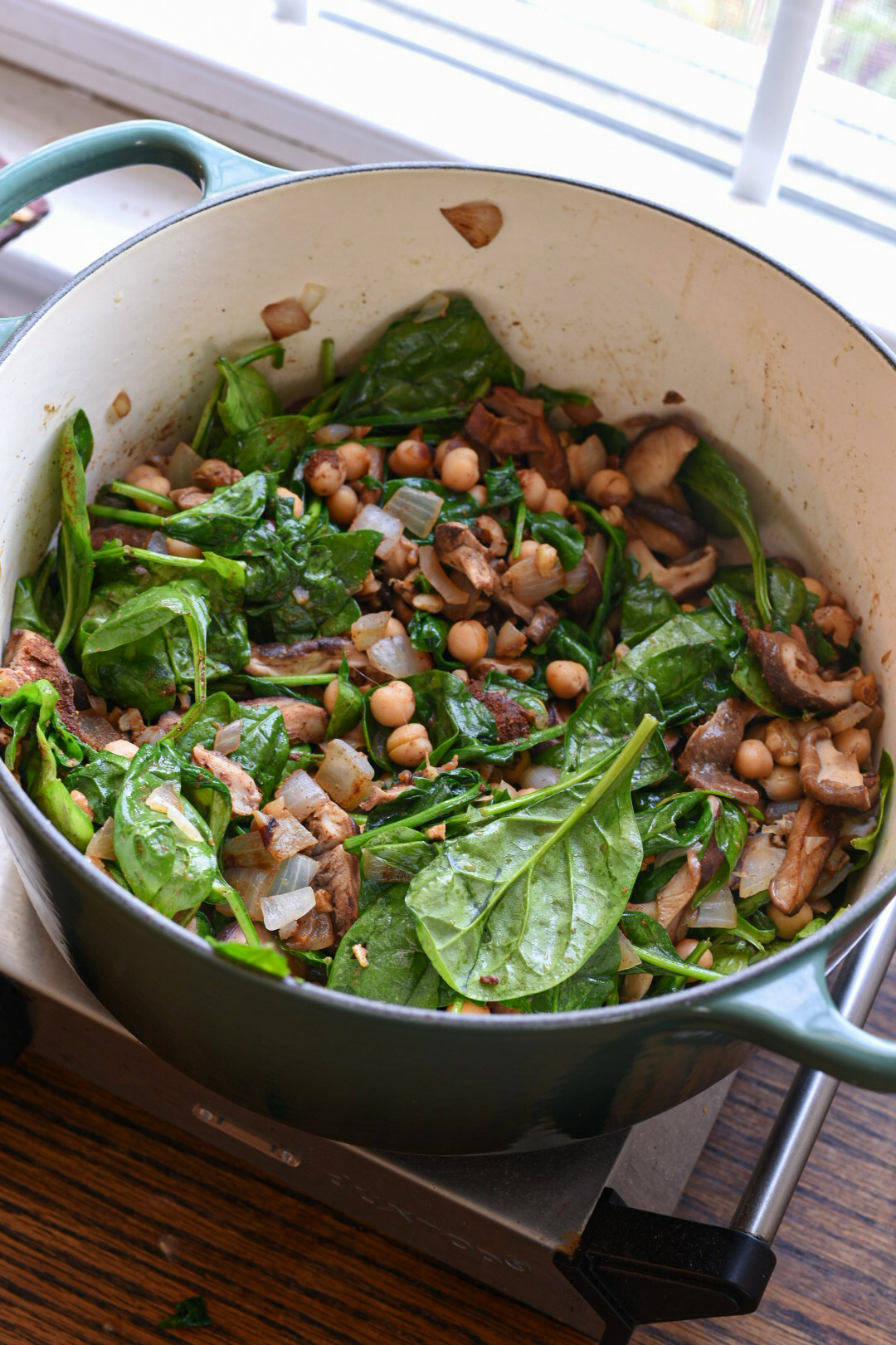 Barley salad recipe with spinach A dutch oven filled with vegetables for barley salad and bright green spinach