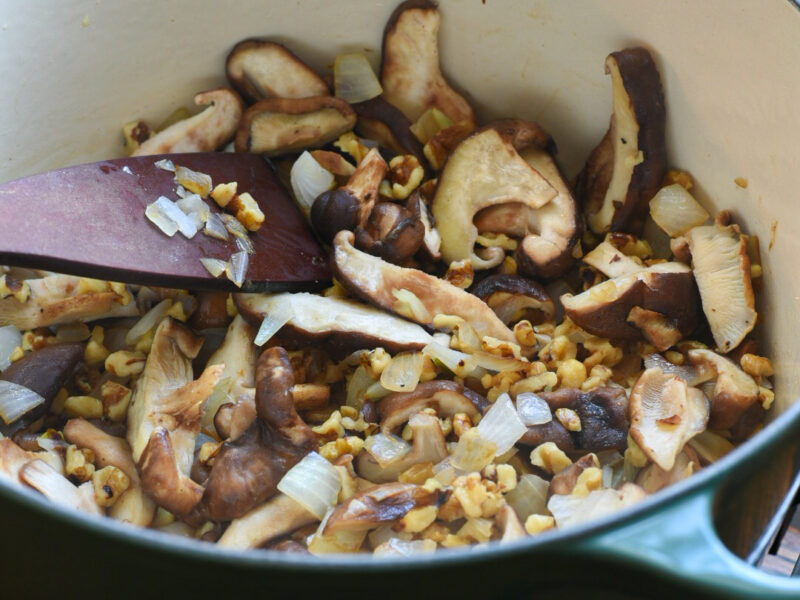 barley salad recipe with walnuts A dutch oven filled with sauteeing shiitake mushrooms and onions