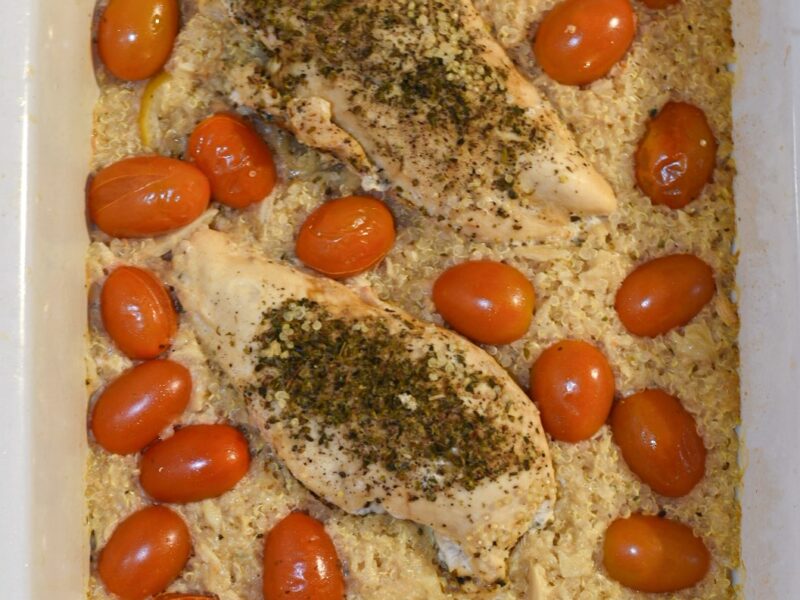crockpot lemon chicken Overhead shot of slow cooker lemon chicken and quinoa with cherry tomatoes and garlic.