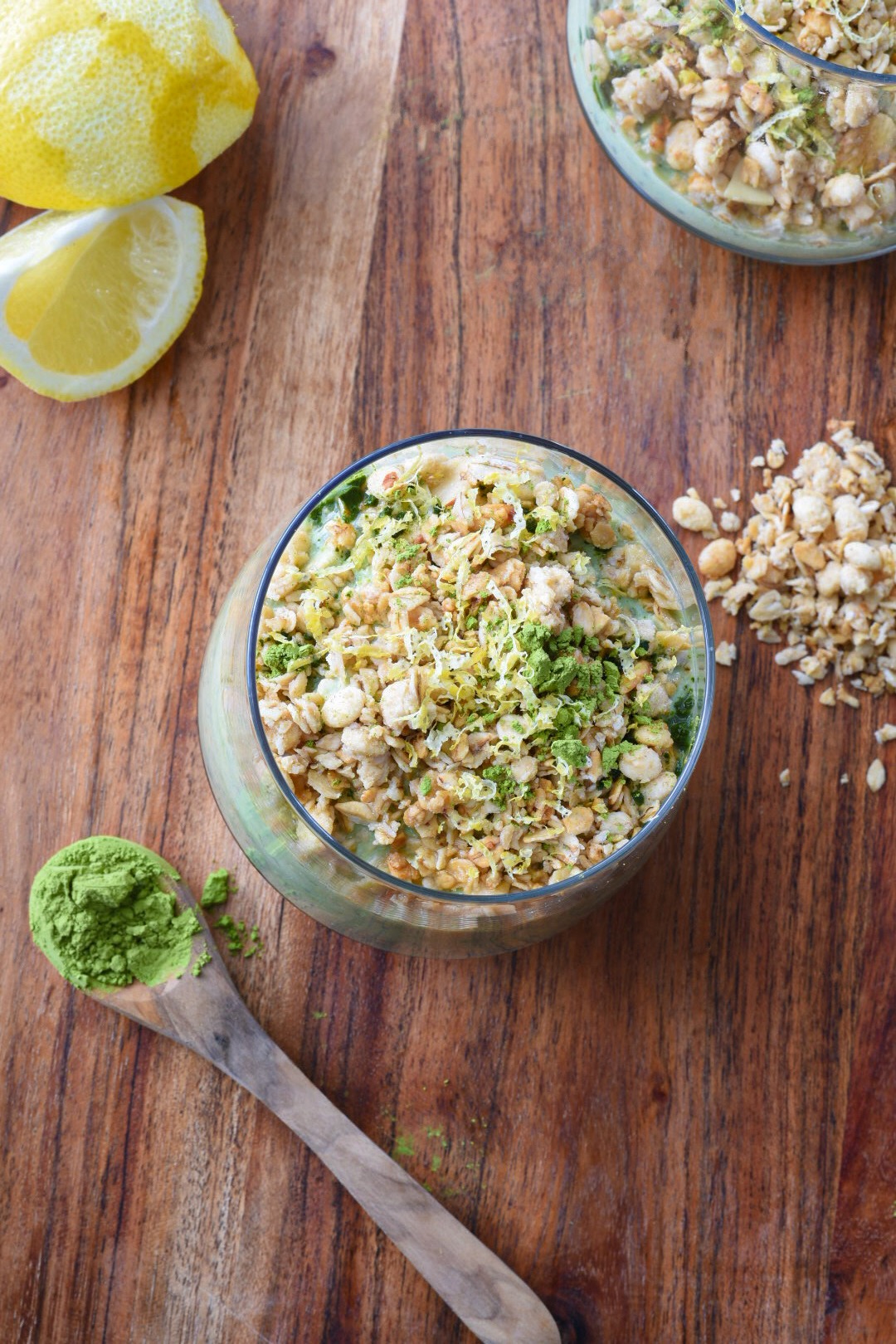 An overhead shot of overnight oats with matcha in a large mason jar with lemons in the corner