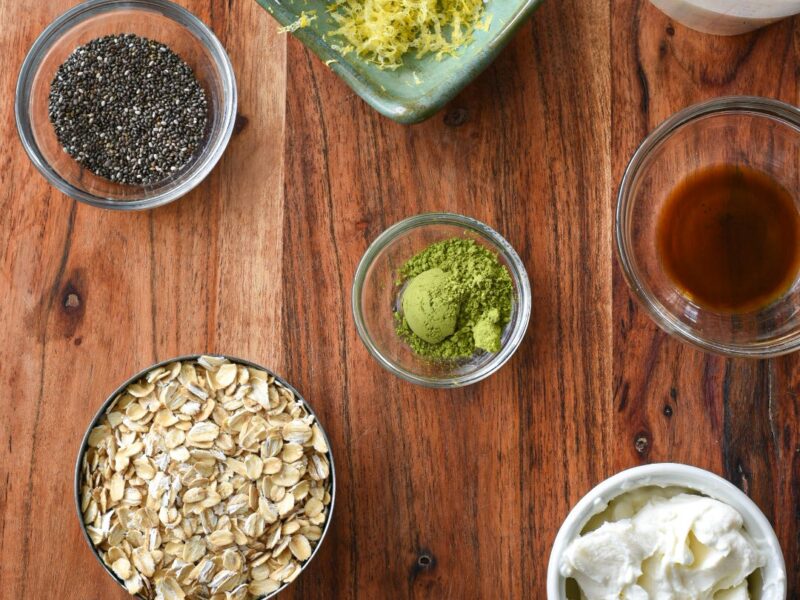 An overhead shot of the ingredients needed to make matcha overnight oats with lemon and honey