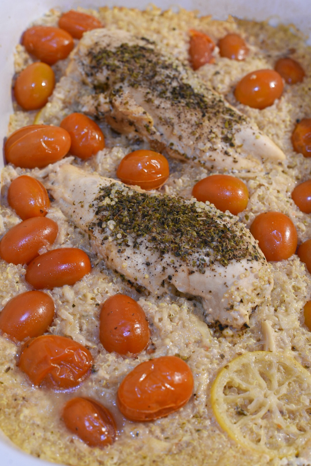 Slow cooked lemon chicken and quinoa in a crockpot with cherry tomatoes and lemon slices
