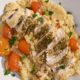 Close up of sliced herb chicken breast on quinoa surrounded by cherry tomatoes and parsley