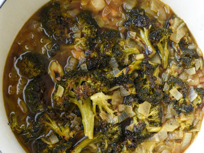 Broccoli feta soup with almonds boiling in a dutch oven