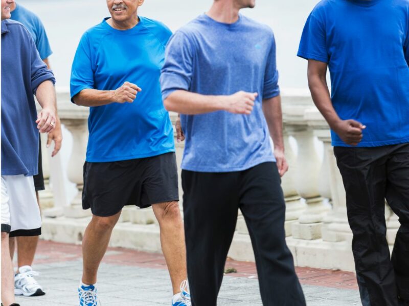 A group of men walking together all wearing blue