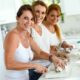 Three friends in the kitchen cooking