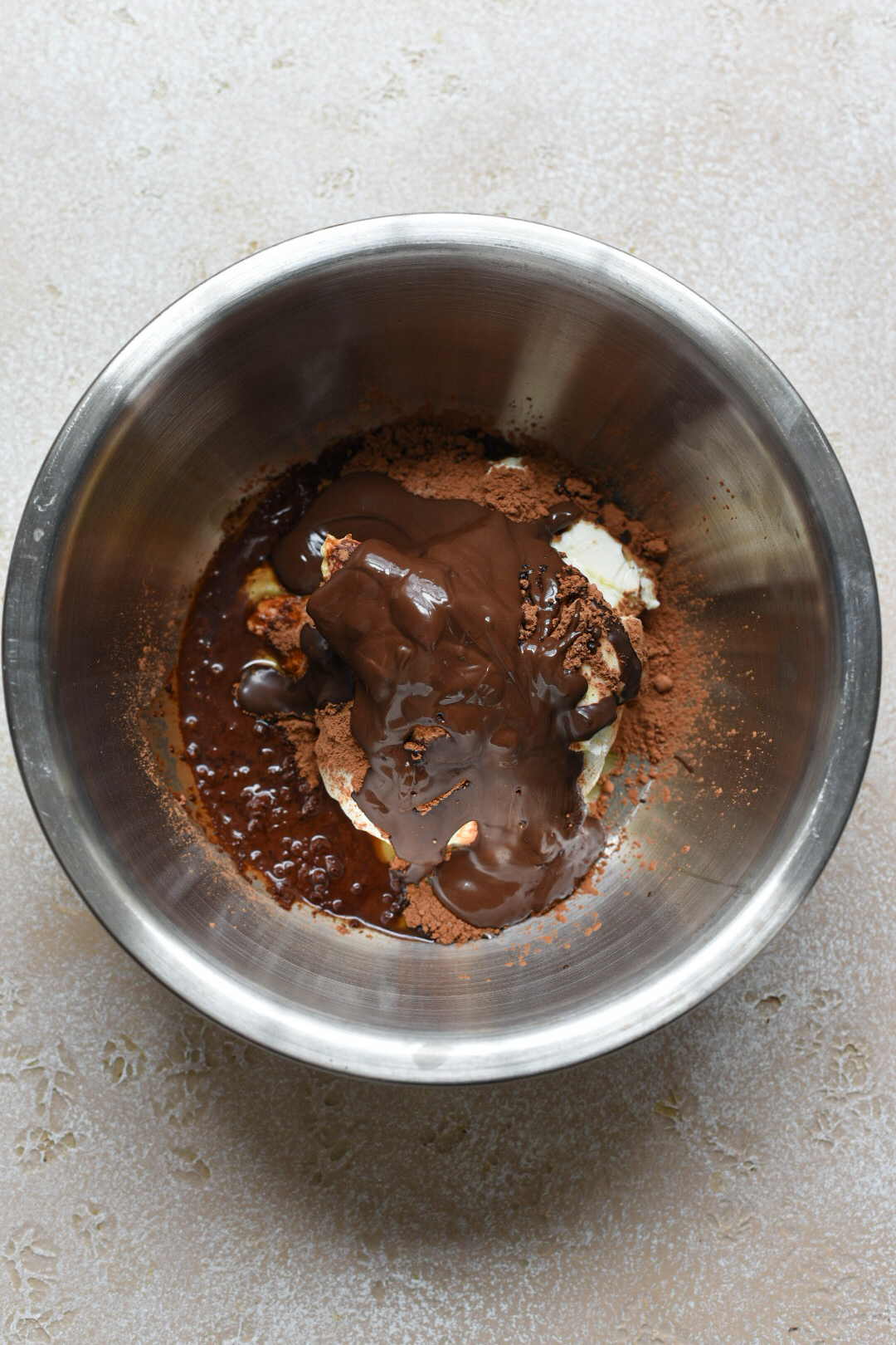 The ingredients for chocolate greek yogurt mousse in a metal mixing bowl