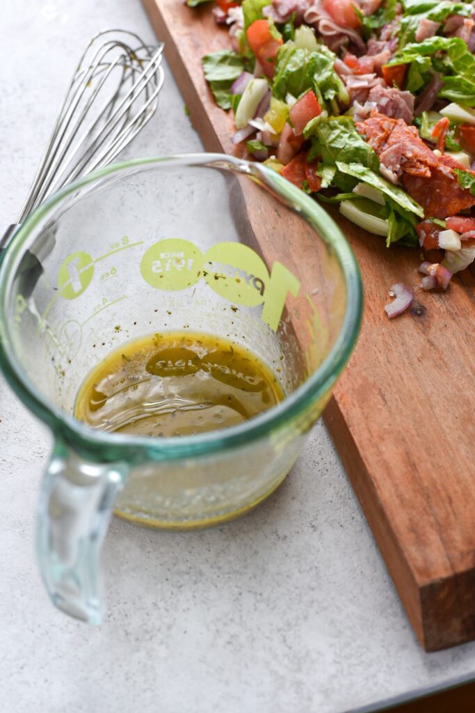 italian sandwich dressing Italian sandwich dressing in a glass measuring cup.