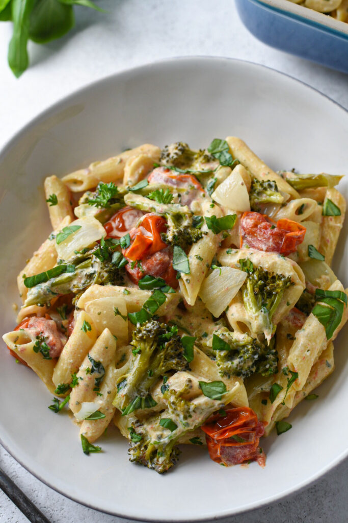 boursin cheese pasta A boursin cheese pasta dish in a white bowl topped with basil.