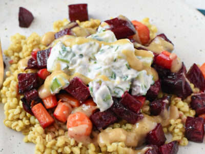 Roasted beets and carrots over barley topped with a tahini sauce and cucumber yogurt.