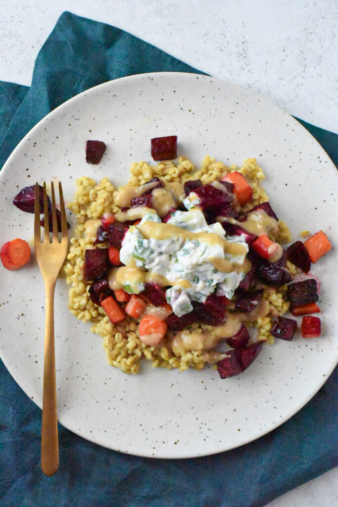 An overhead shot of a plate filled with roasted a roasted beets and carrots recipe.