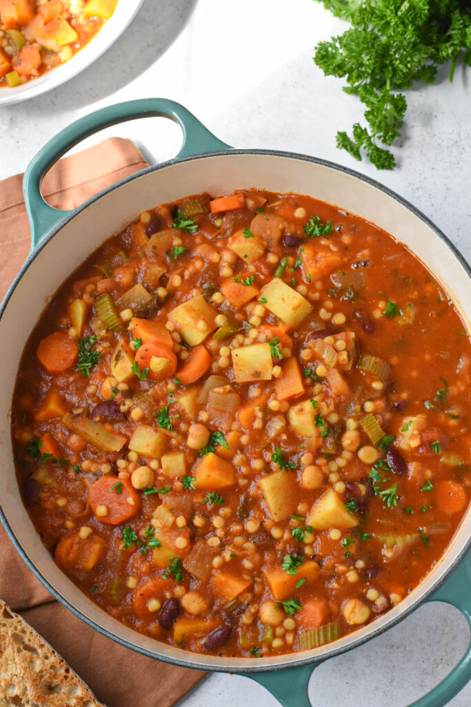 sardinia minestrone soup An overhead image of a le creuset pot filled with sardinian minestrone soup