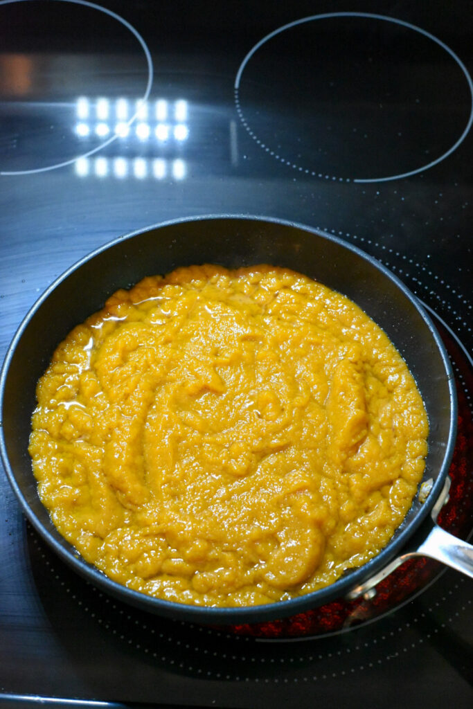 Pumpkin puree being sauted in a non-stick skillet.