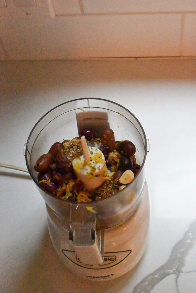 The ingredients used for olive and walnut crusted salmon in a food processor.