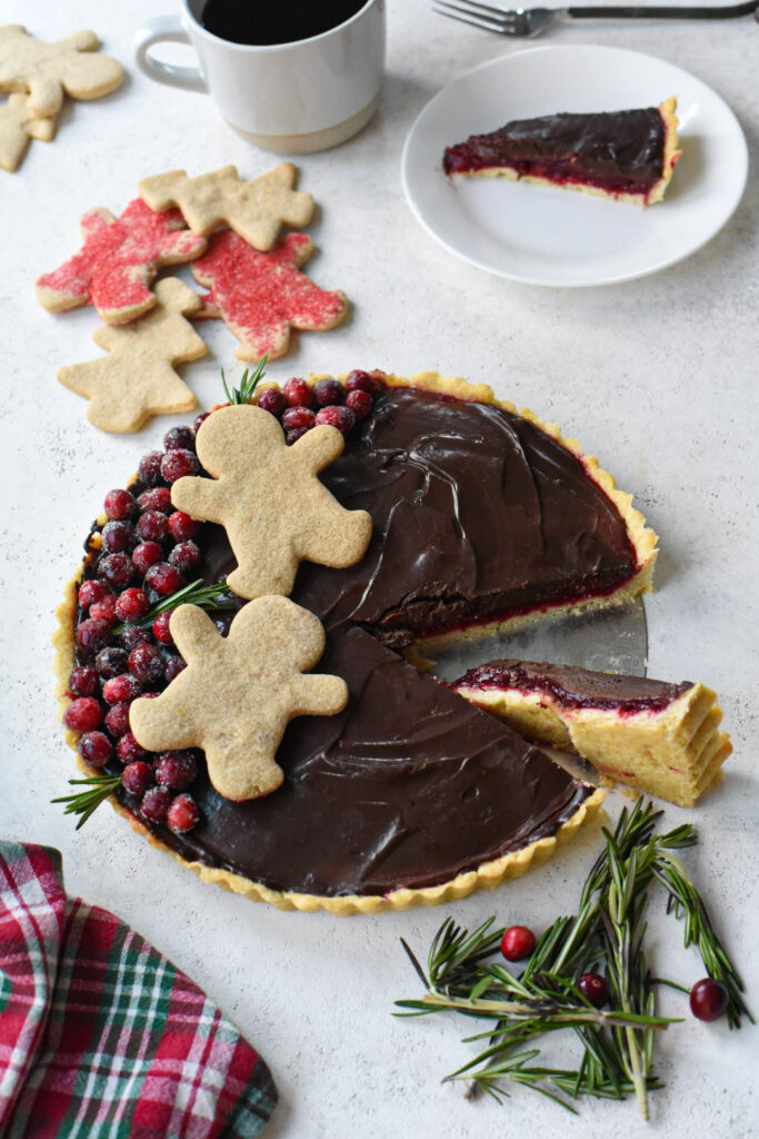 An overhead image of chocolate ganache tart with cranberry filling.