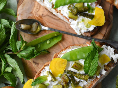 A few pieces of burrata toast with asparagus, snap peas and garlic confit.